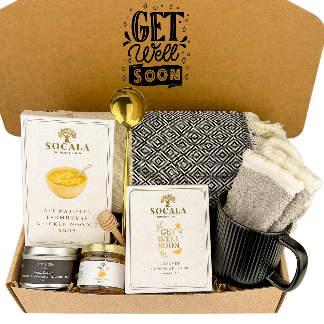 Get well soon care package with SOCALA products and a mug with a blanket and hot chocolate.