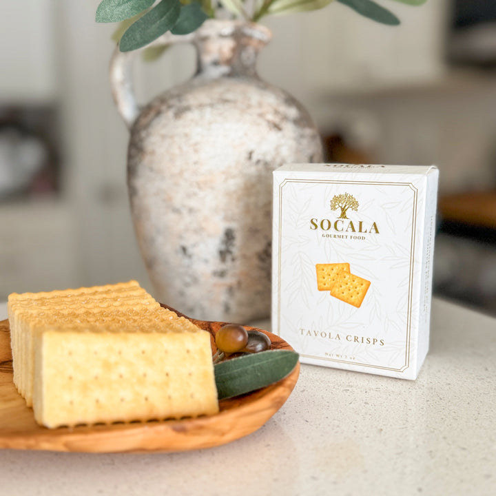 Box of Socala crackers on a table with crackers and cheese