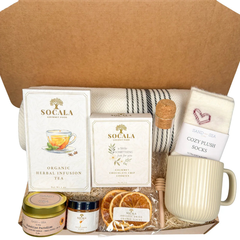 Tea gift set with a luxury blanket, Socala tea, a mug, and other items in a box.