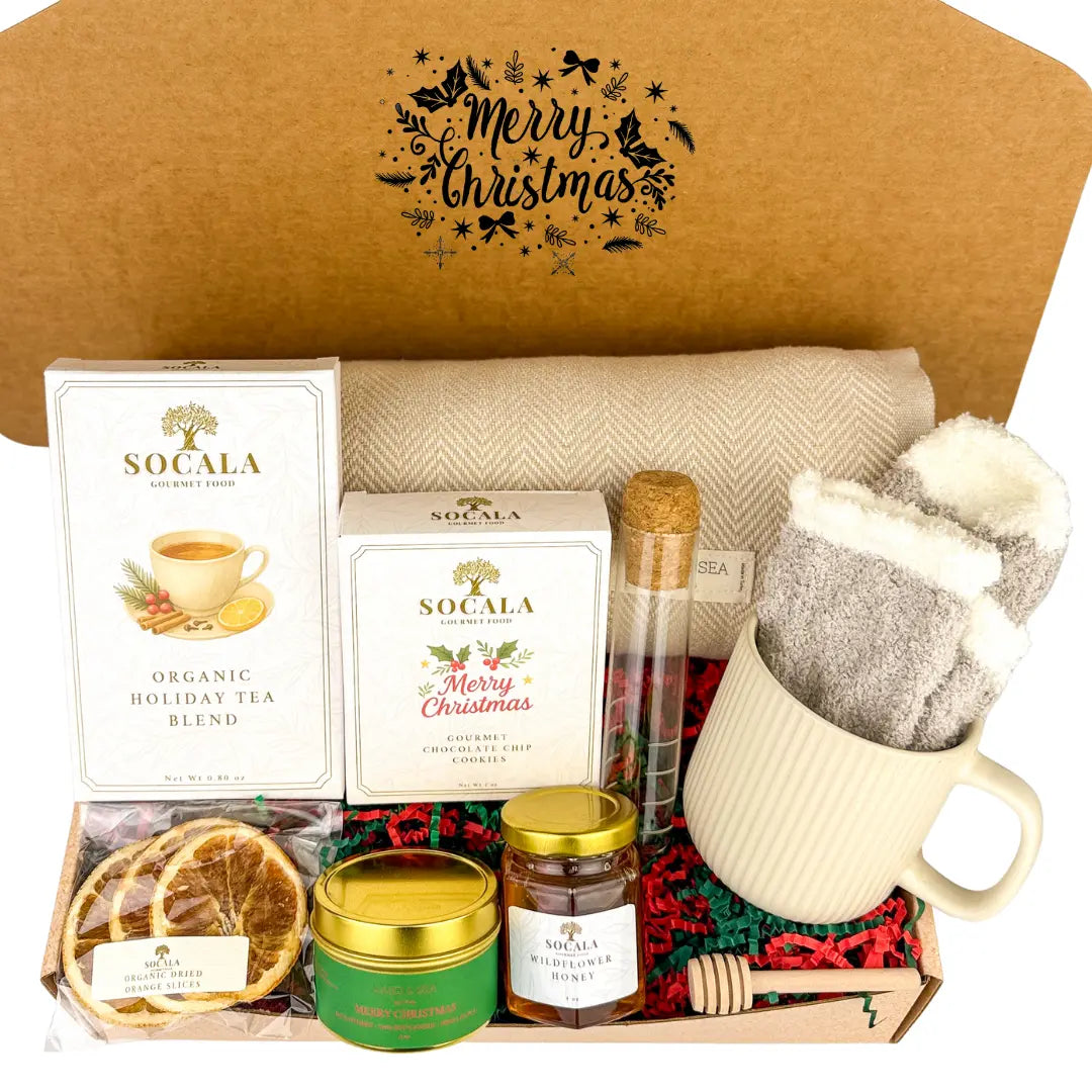 Gift set with tea, cookies, and other items in a decorative box with 'Merry Christmas' text.