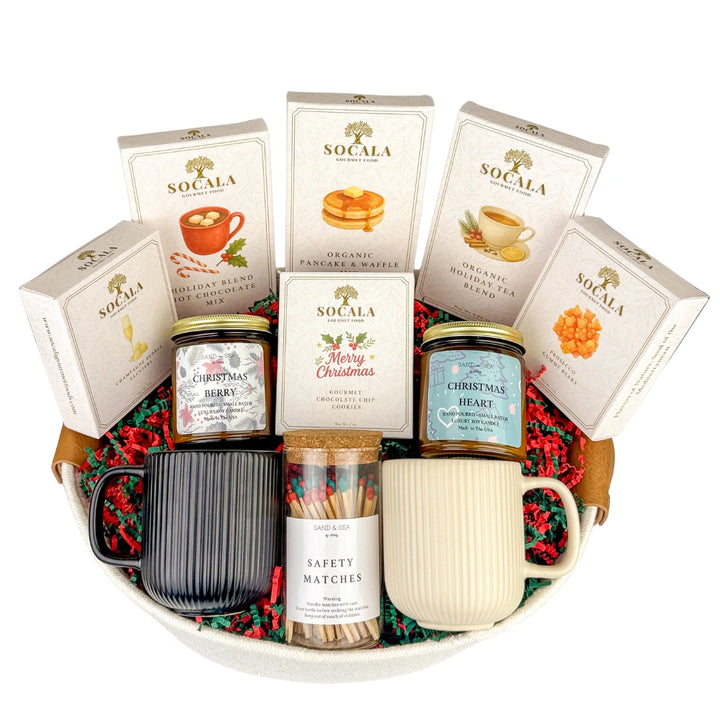 Gift basket with tea packages, a mug, and other items on a white background
