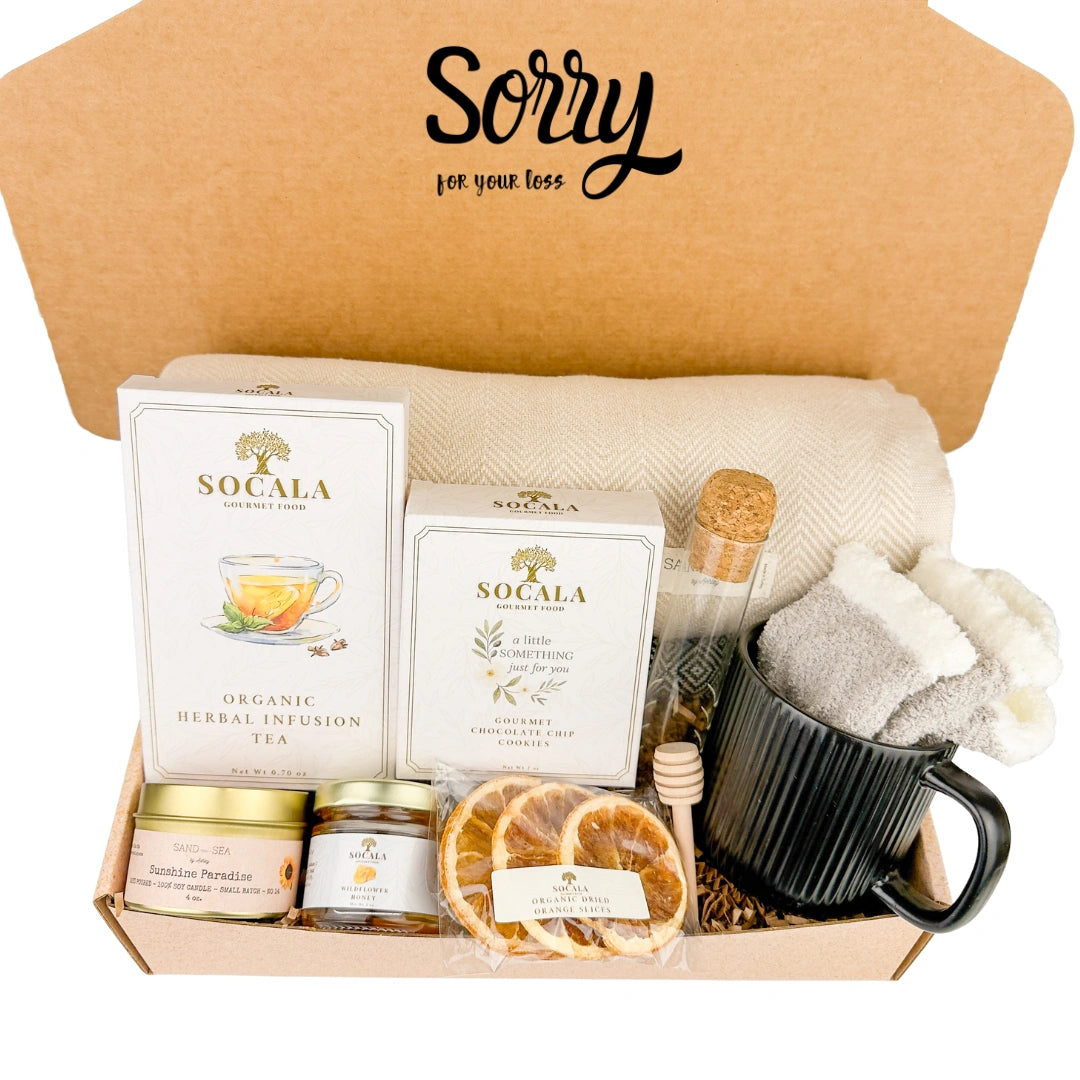Gift box with blanket, tea, snacks, and a mug labeled 'Sorry for your loss'.