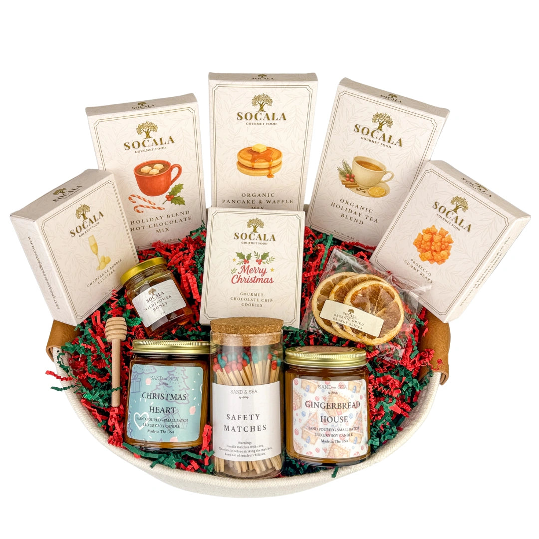 Gourmet gift basket with various items including tea, honey, and cookies on a white background