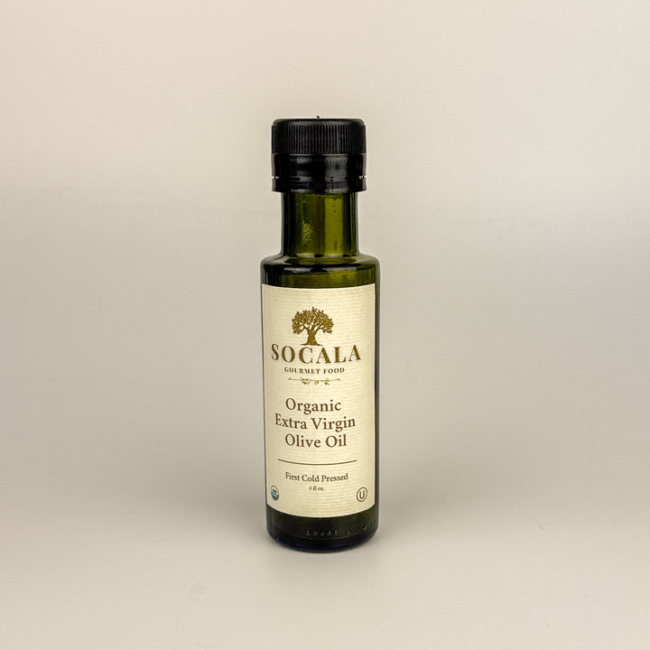 Bottle of Socala Organic Extra Virgin Olive Oil on a beige background