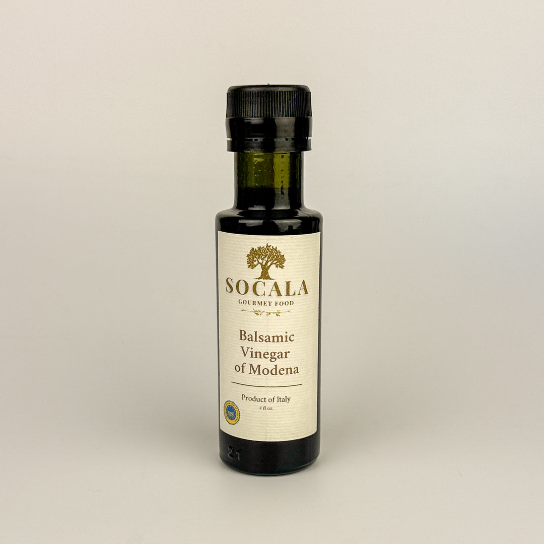 Bottle of Socala Balsamic Vinegar of Modena on a beige background