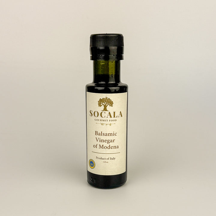 Bottle of Socala Balsamic Vinegar of Modena on a beige background