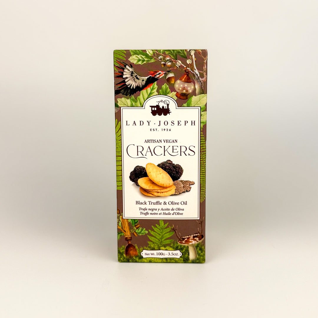 Packaging of Lady Joseph Artisan Vegan Crackers with black truffle and olive oil flavor on a beige background.
