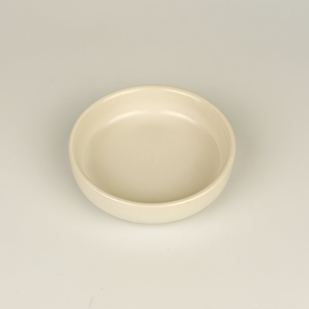 White ceramic bowl for dipping on a light gray background