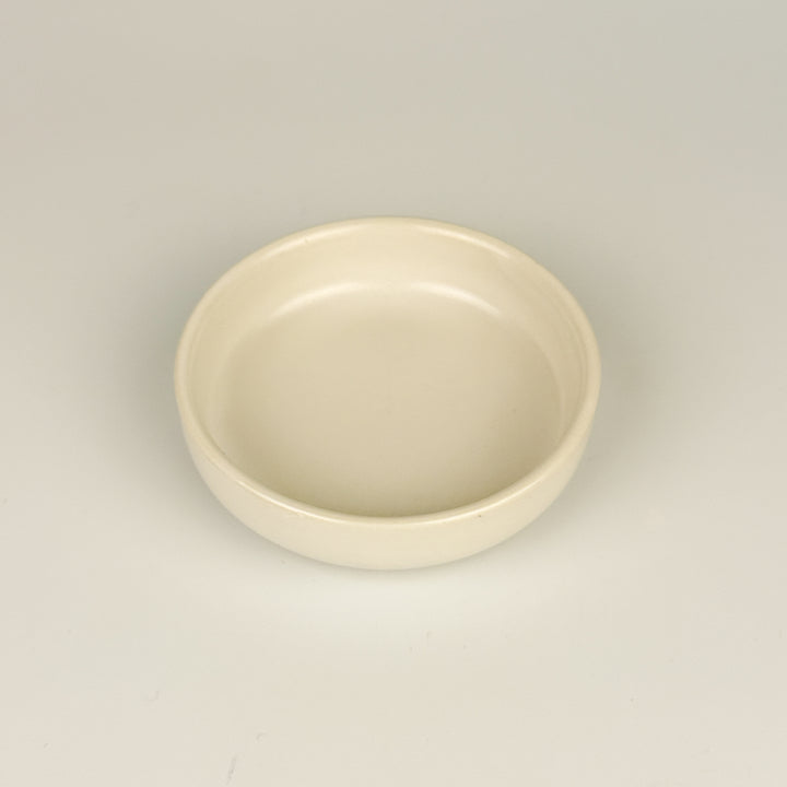 White ceramic bowl for dipping on a light gray background
