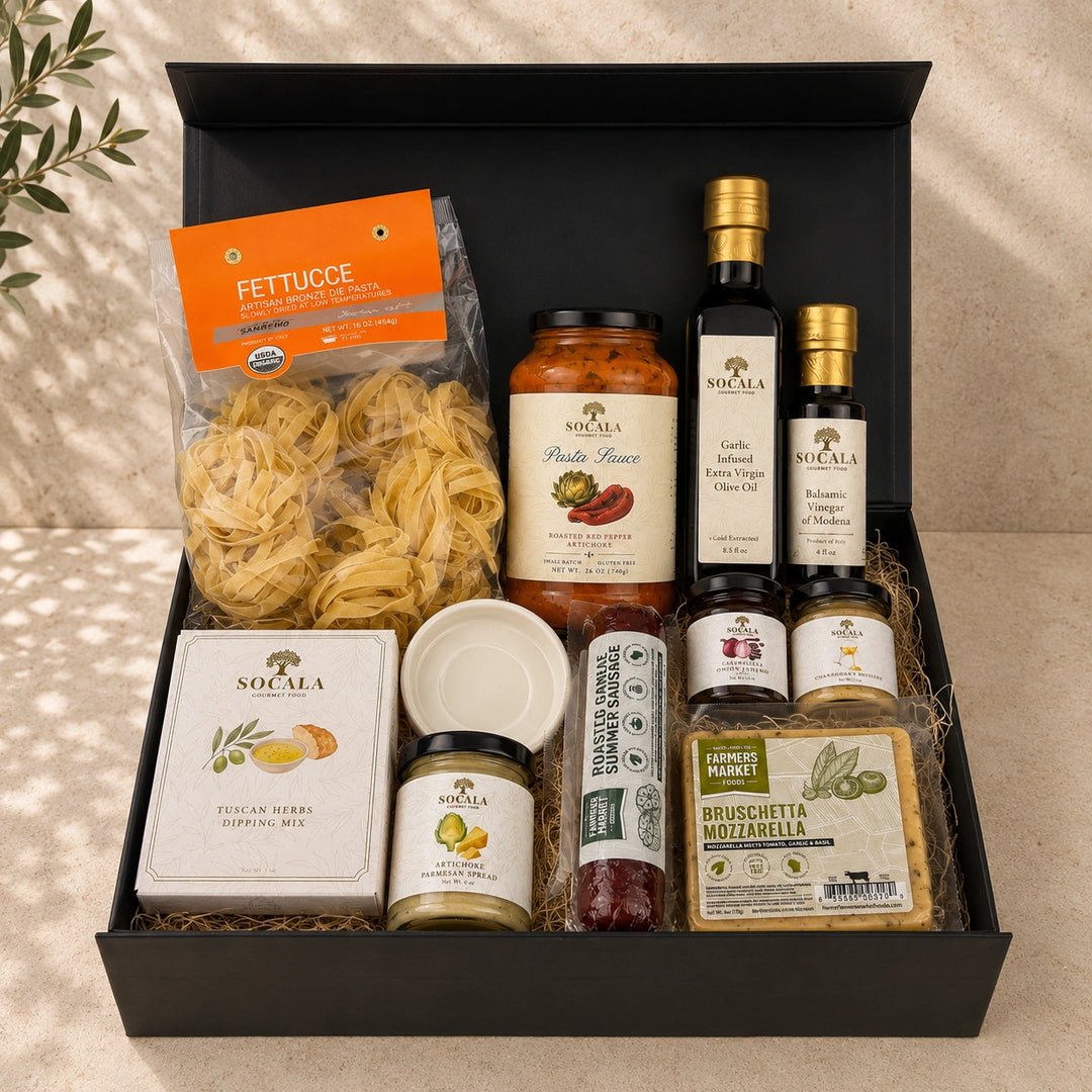 Gourmet gift basket with pasta, sauces, and other Italian food items in a black box.
