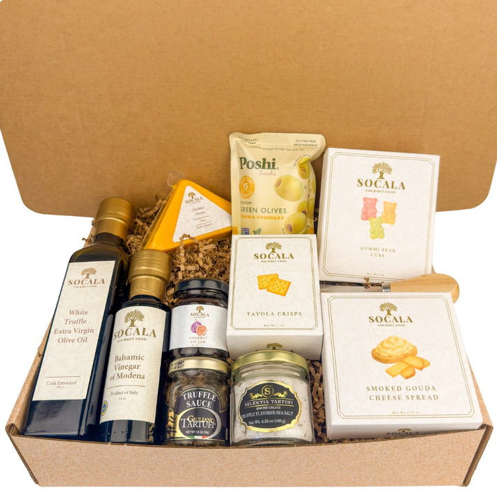 Gourmet food gift set with various items including olive oil, cheese, and crackers in a cardboard box.