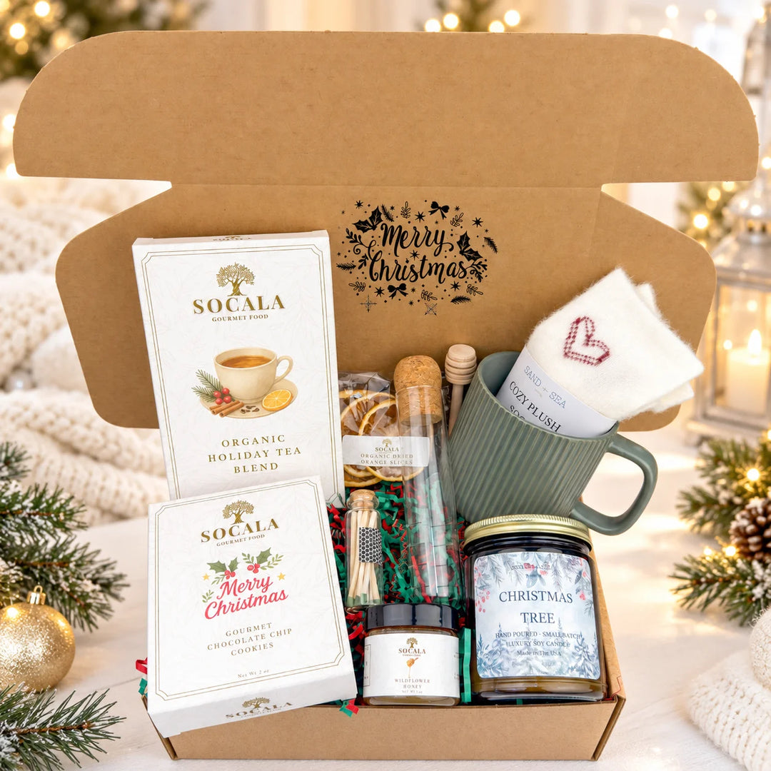 Gift set with Socala tea, honey, and candles in a box with 'Merry Christmas' text.