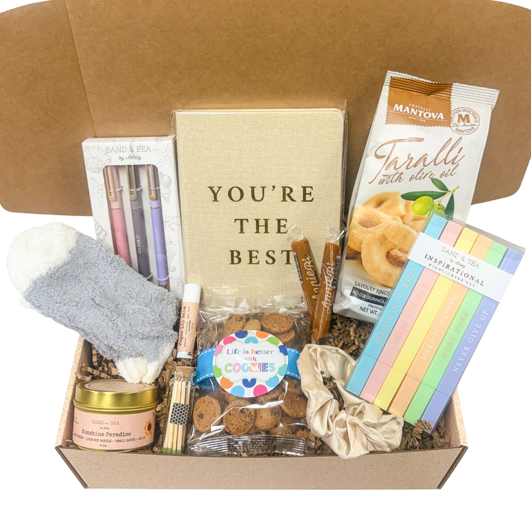 Collage Care Package with various items, including cookies, candles, and stationery, on a white background.
