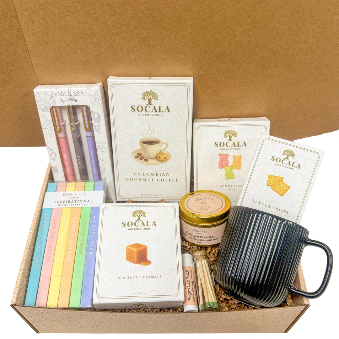 Gift box with SOCALA products including coffee, tea, and a mug on a brown background