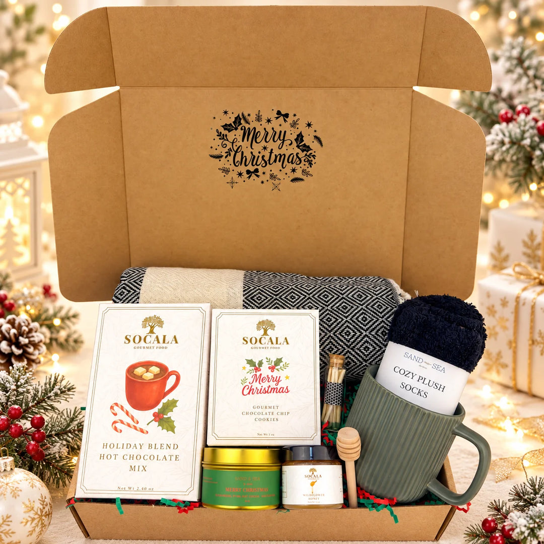 Gift box with holiday-themed items including hot chocolate mix, mug, and cookies.