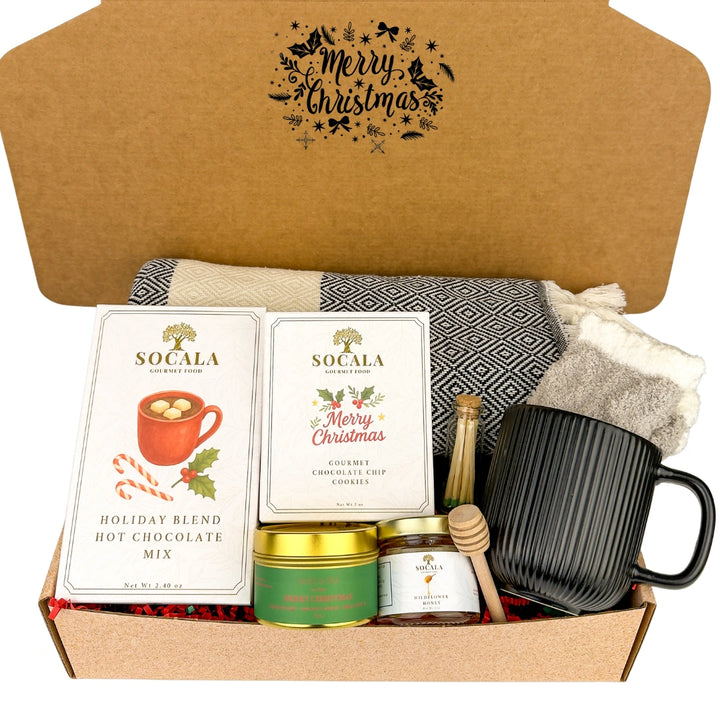 Gift box with holiday-themed items including hot chocolate mix, mug, and cookies.