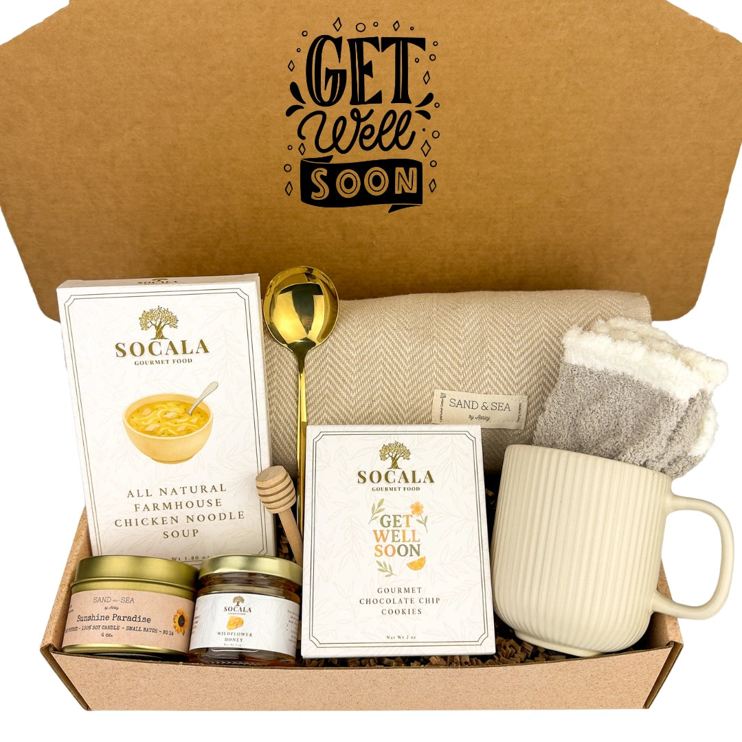 Get well soon care package with a mug, chicken noodle soup, cookies, and other items in a box.