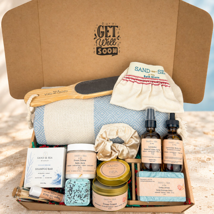 A curated beach wellness gift set in a brown cardboard box labeled &