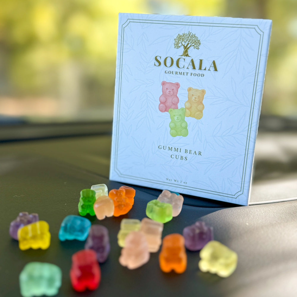 Colorful gummy bear candies in front of a SOCALA Gourmet Food package.