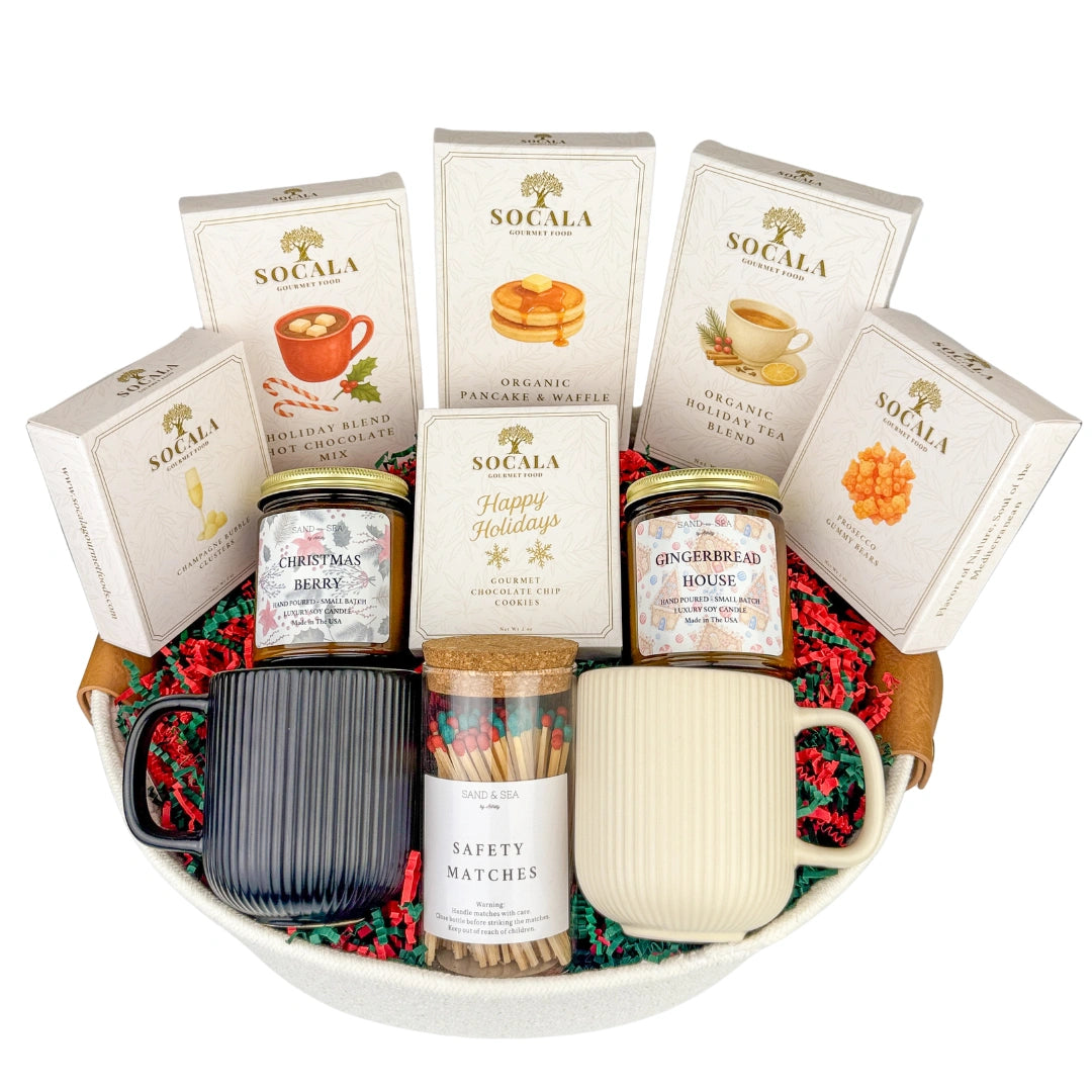 Gift basket with mugs, hot chocolate mix, and other items on a white background