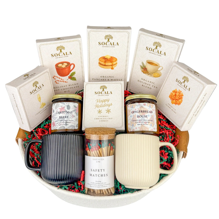 Gift basket with mugs, hot chocolate mix, and other items on a white background