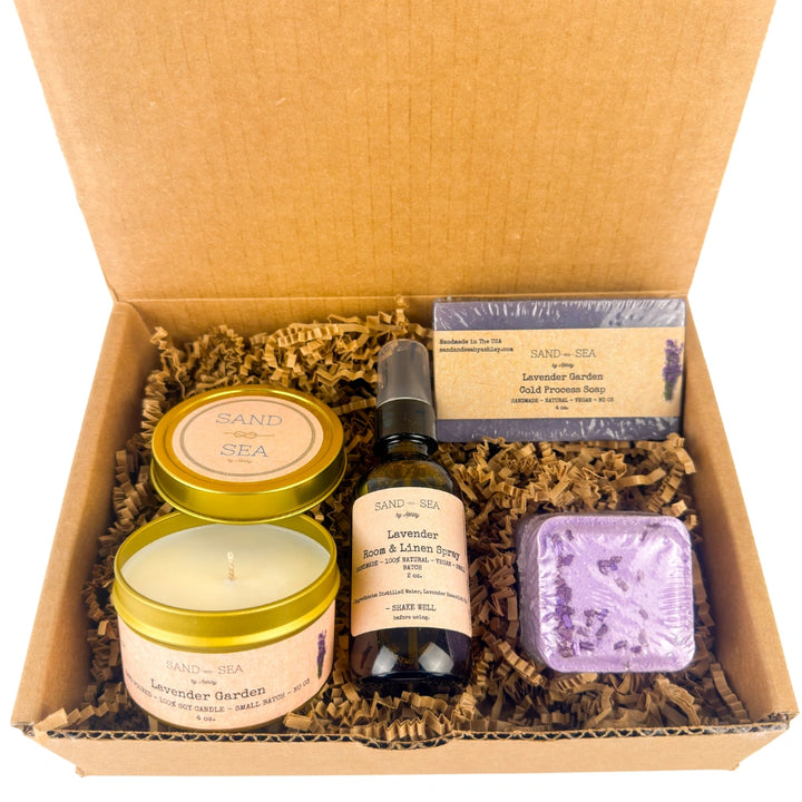 Gift set with candles, soap, and other items in a cardboard box