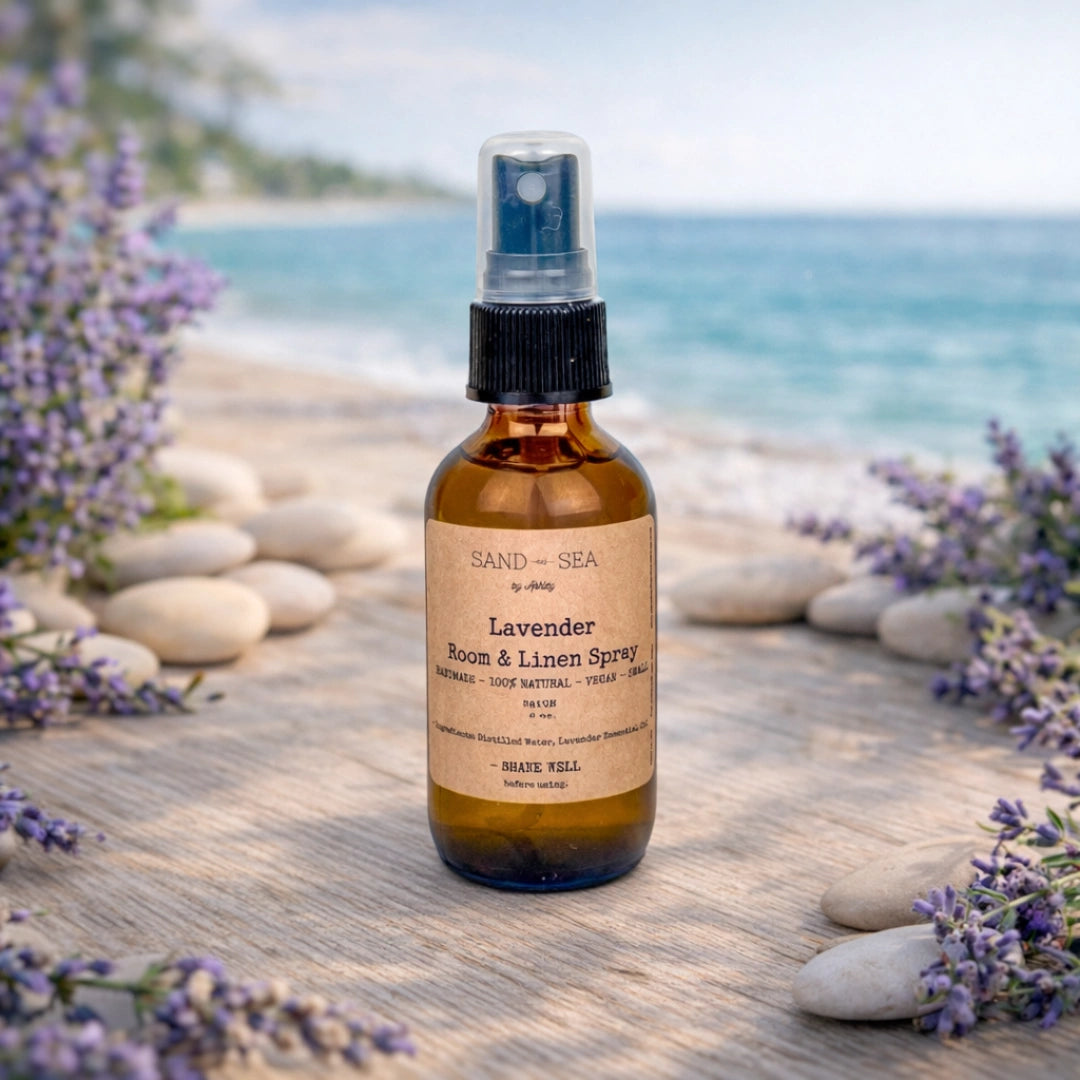 Lavender room and linen spray bottle on a wooden surface with lavender flowers and a beach background