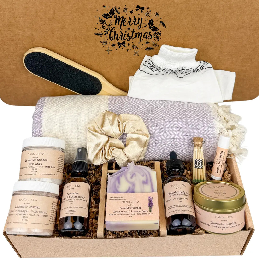 Merry Christmas Gifting box with self-care products including a scrub brush, towel, and various skincare items on a brown background.