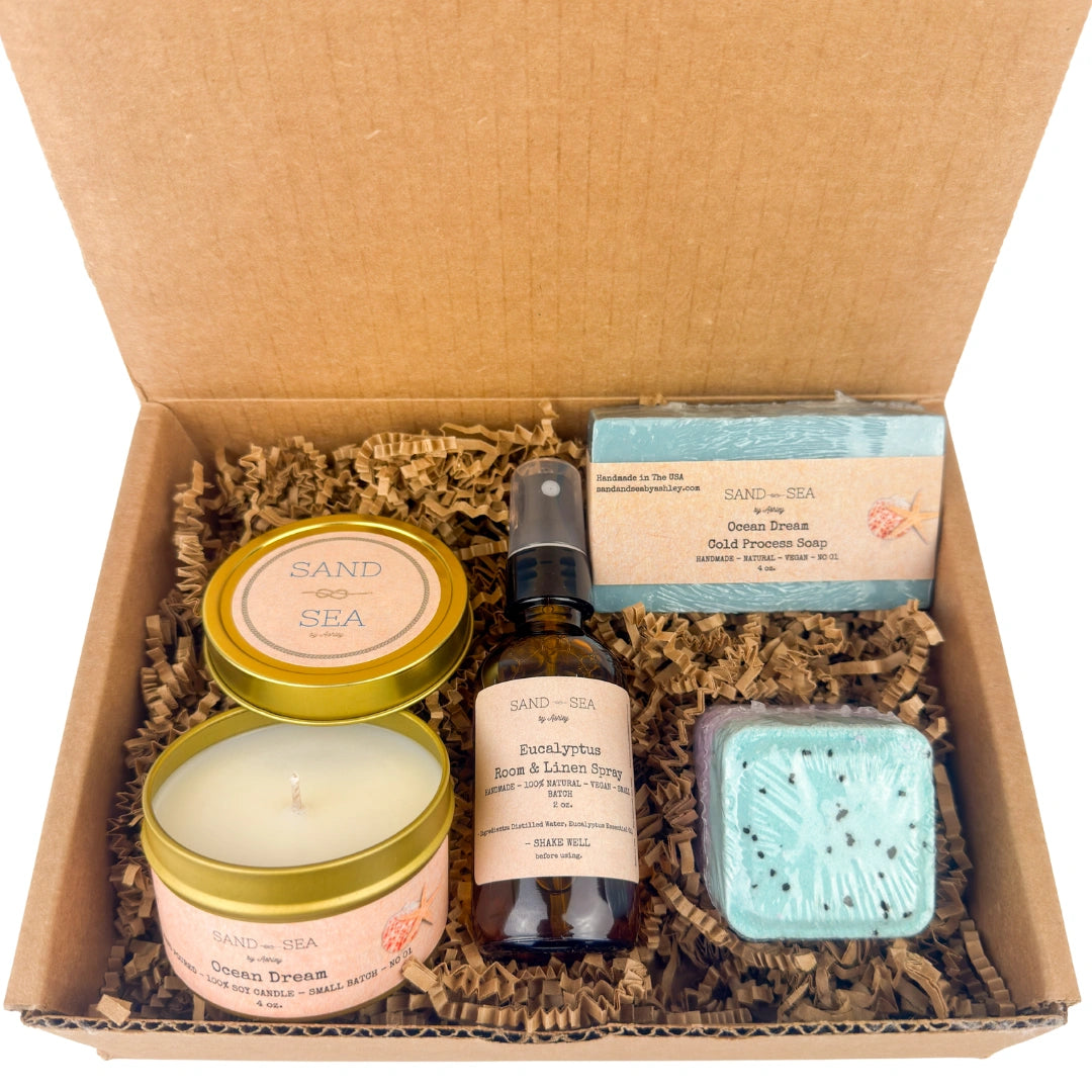 Box of Sand & Sea products including candles, soap, and essential oil spray.