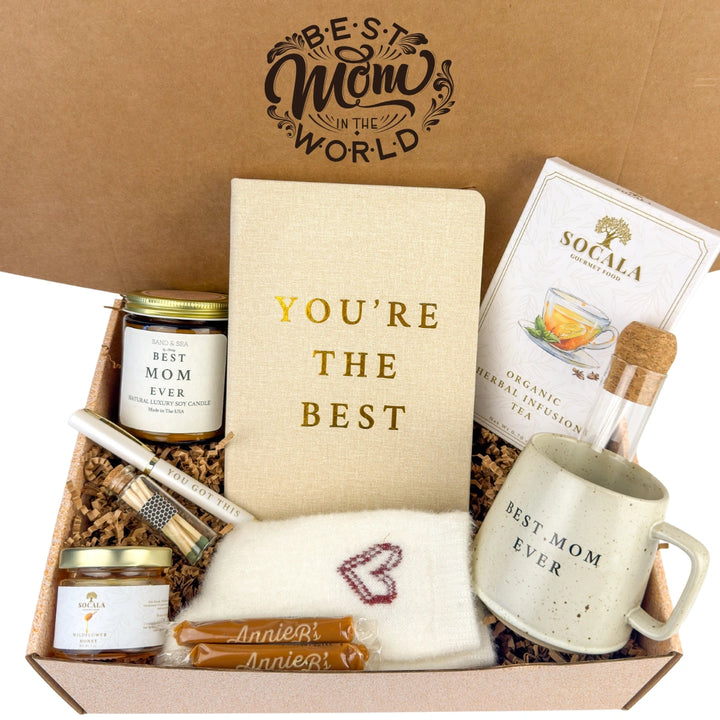 Gift box with 'Best Mom in the World' and 'You're the Best' items, including a mug, tea, and notebook.