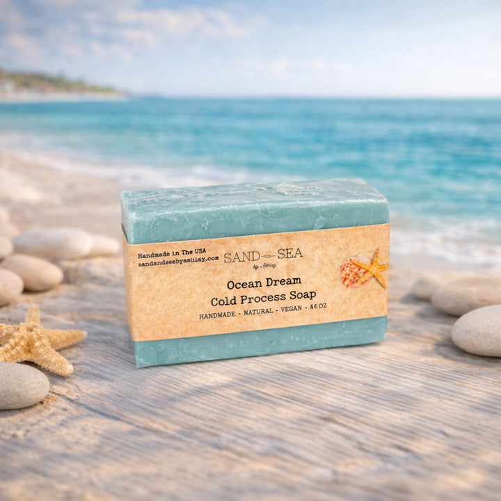 Bar of soap with a 'Sand & Sea' label on a beach setting