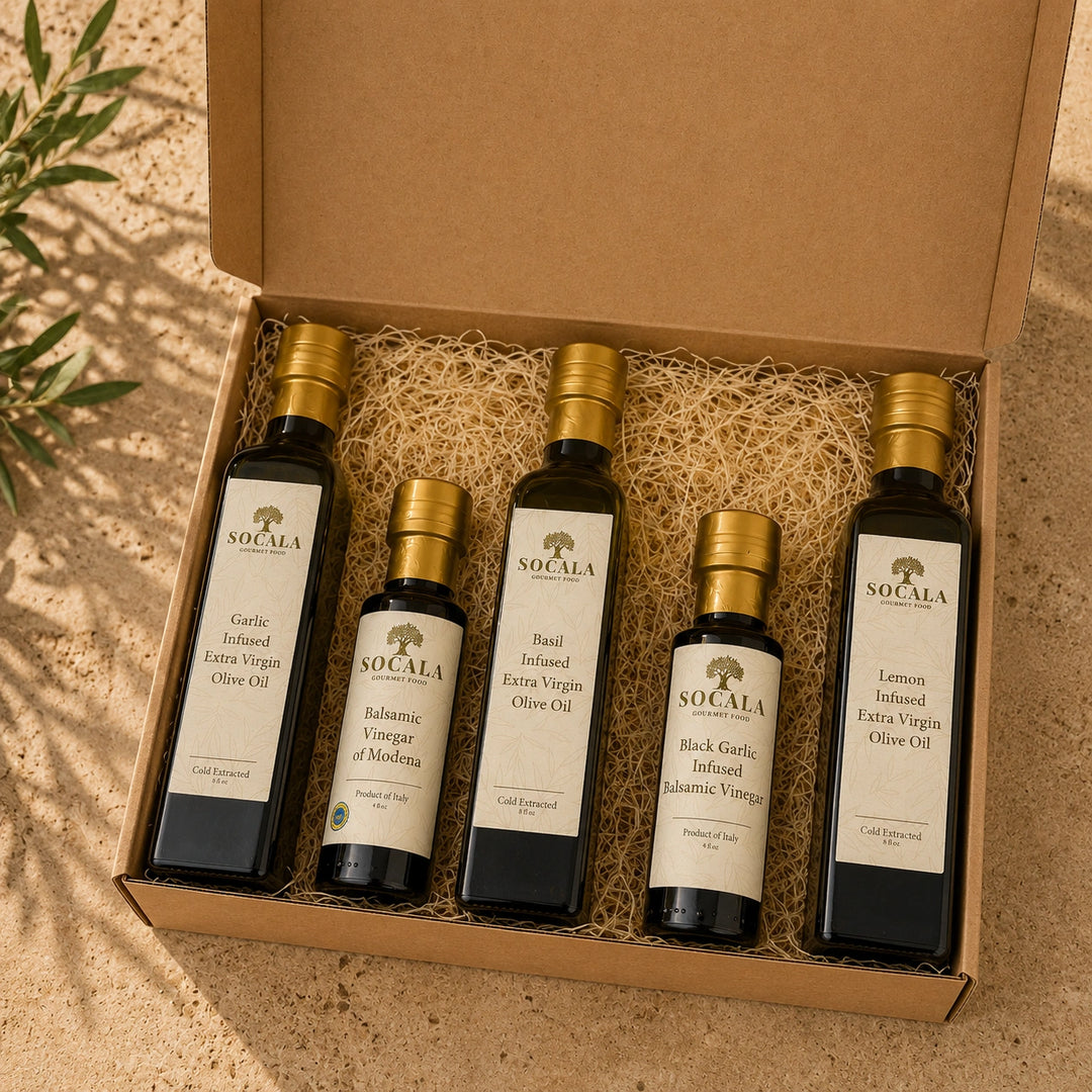 Set of five Socala olive oil and vinegar bottles in a box on a textured surface.