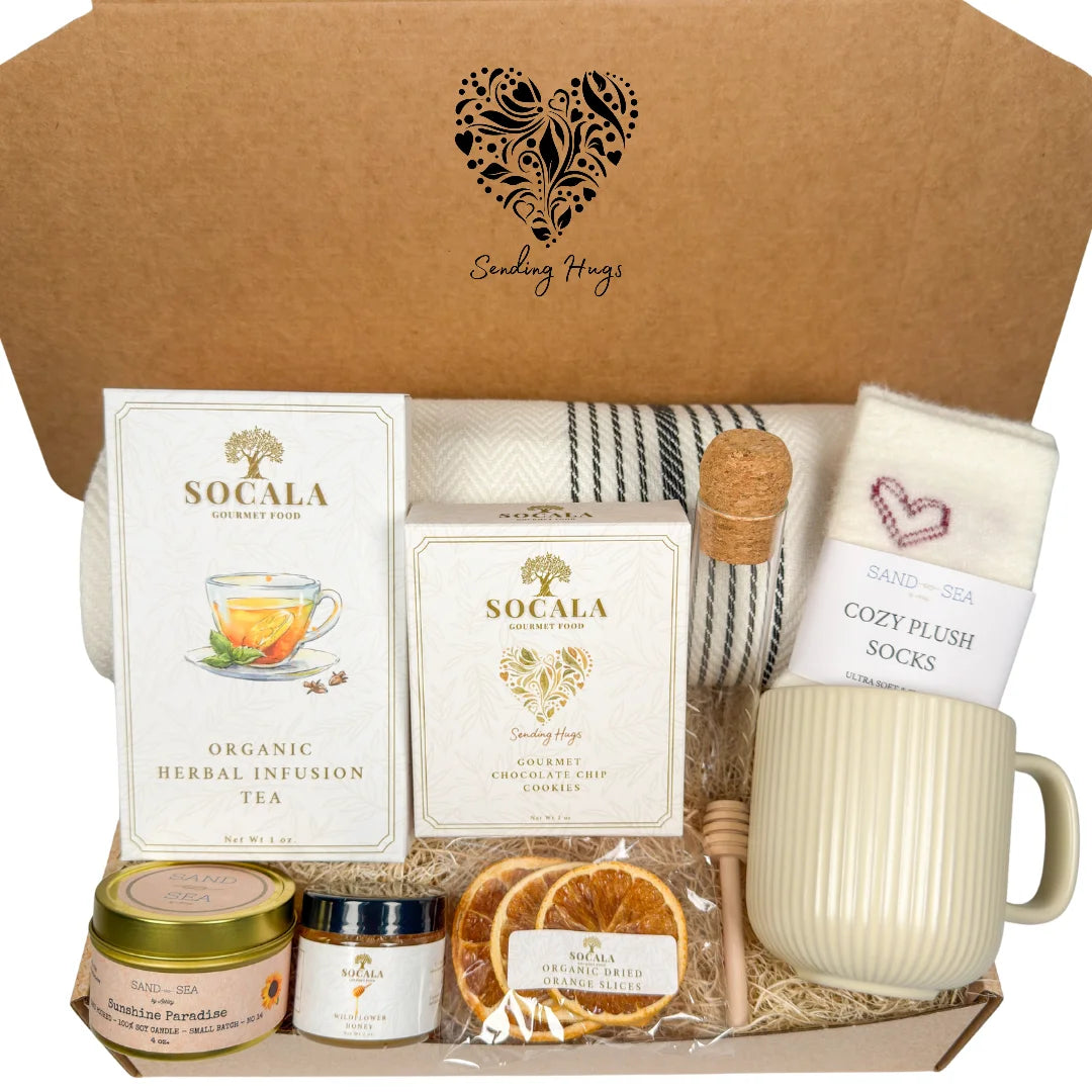 Blanket and tea gift set with 'Socala' tea boxes, a mug, and other items in a decorative box.
