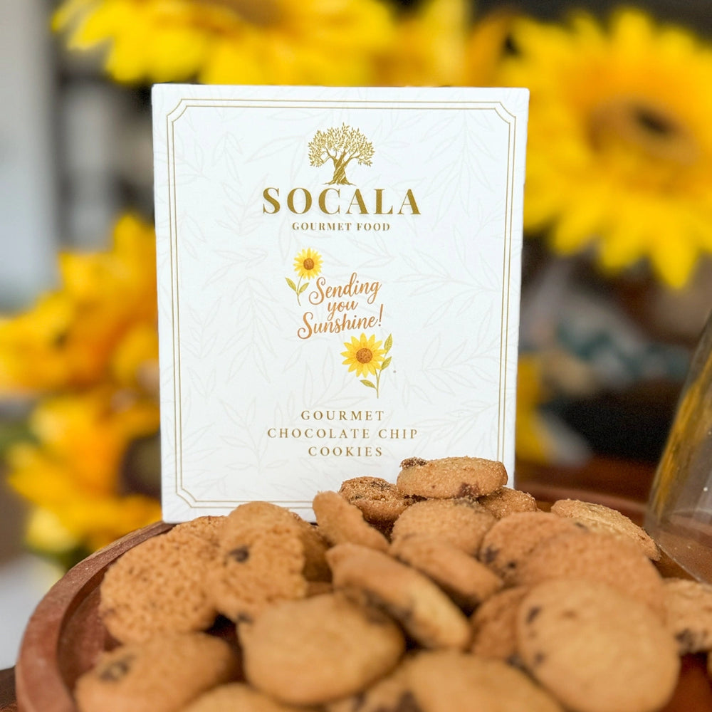 Socala Gourmet Food cookies with a 'Sending you Sunshine!' card in front of sunflowers.