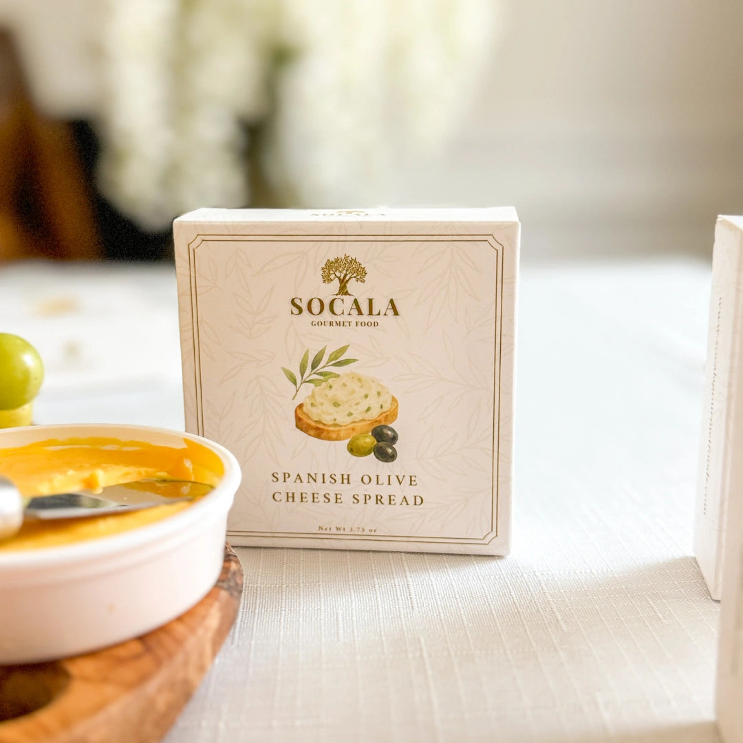Box of Socala Spanish Olive Cheese Spread on a table with a blurred background