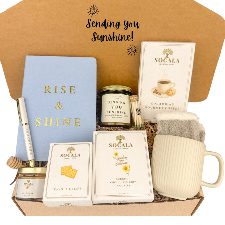 Gift box with 'Rise & Shine' notebook, candles, and coffee, labeled 'Sending you Sunshine!'.