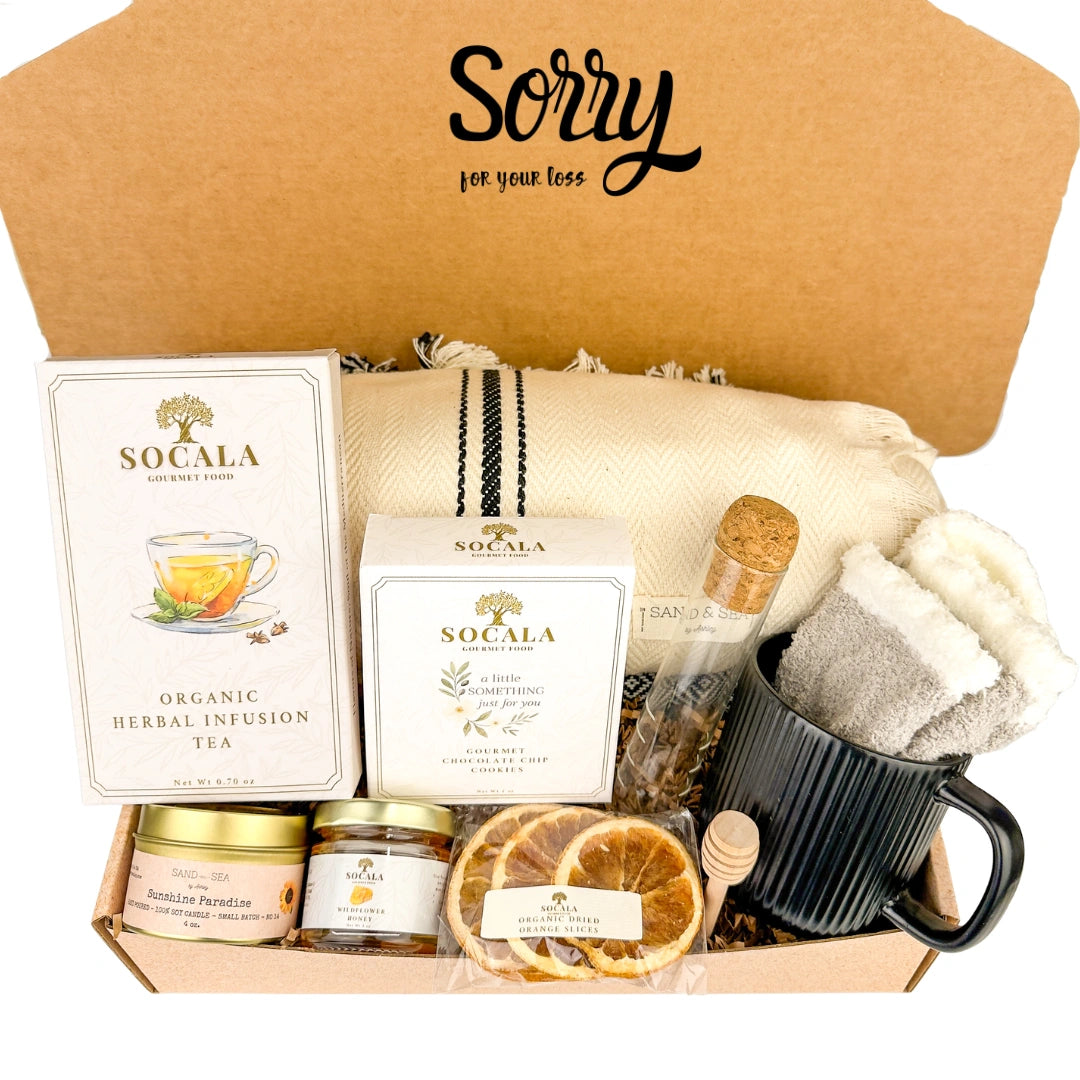 Gift box with tea, snacks, and a mug labeled 'Sorry for your loss'.