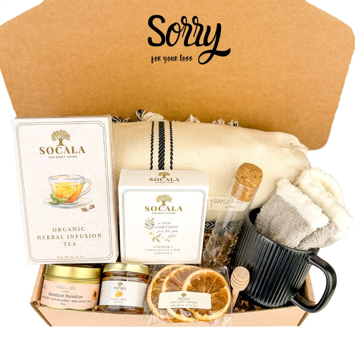 Gift box with tea, snacks, and a mug labeled 'Sorry for your loss'.