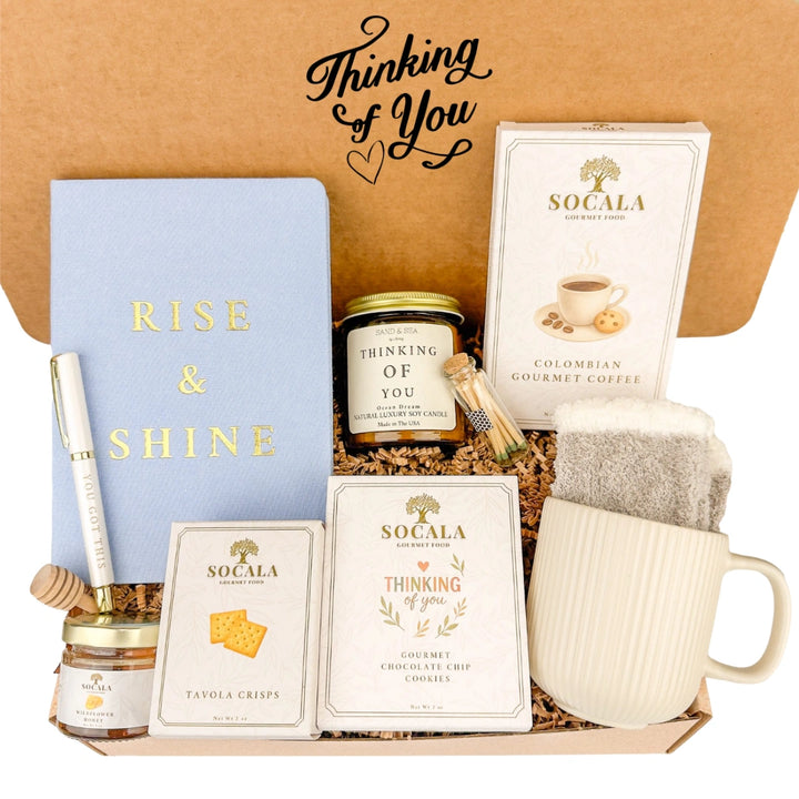 Gift set with 'Thinking of You' items including a mug, snacks, and a notebook.